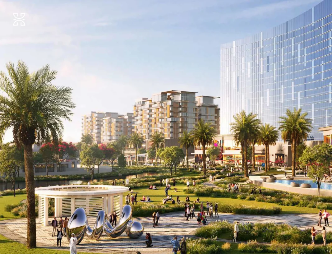 dubai-investitii-imobiliare proiecte imobiliare în Dubai, ansamblu rezidențial, cu spații verzi, palmieri, sculpturi și clădiri noi în fundal